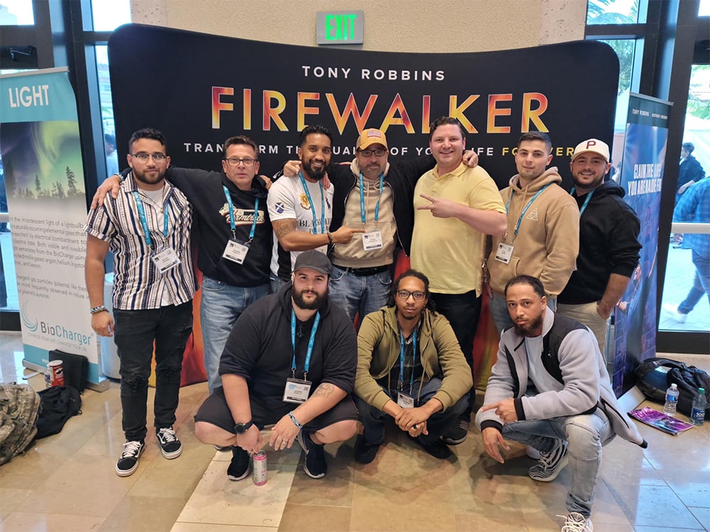 Firewalkers event group photo at tech conference, Tony Robbins Firewalker presentation, diverse group of attendees networking indoors.