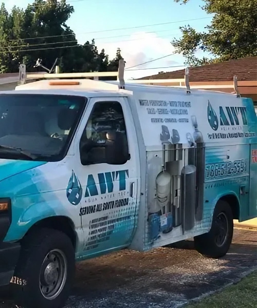 Hozio, Inc. water delivery vehicle promoting plumbing and water services in a city neighborhood.