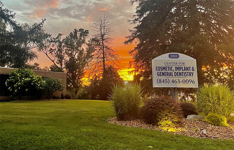 Cosmetic dental clinic sign at sunset, dental practice for implants and general dentistry, Hozio Inc.