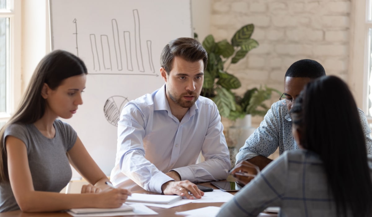 Efficient team meeting discussing data analysis and business strategies at Hozio, Inc. office.