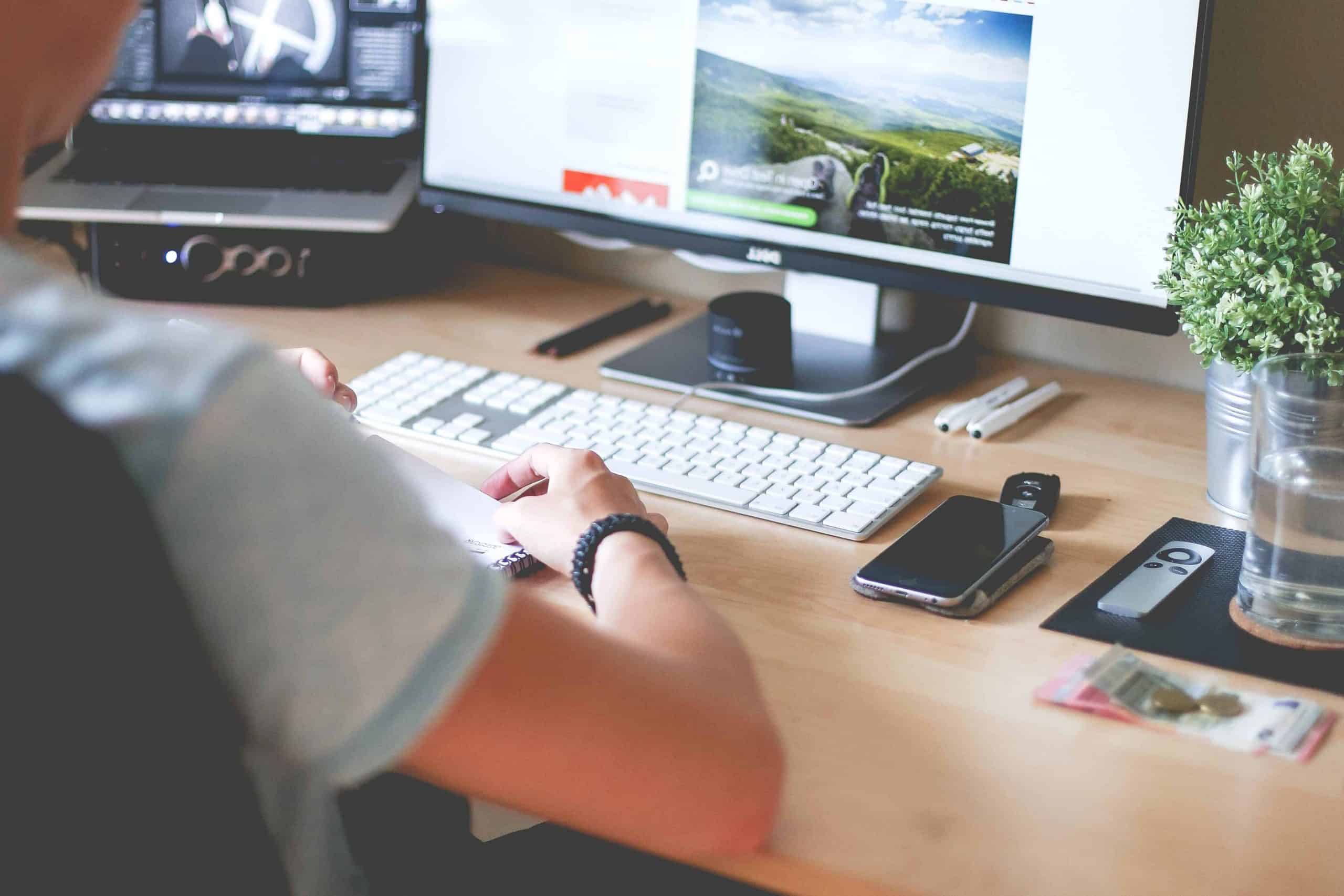 Desktop workspace with computer, smartphone, and office accessories at Hozio.