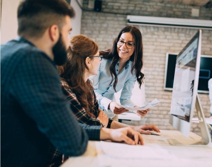 High-energy team meeting collaborating on workspace solutions at Hozio office.