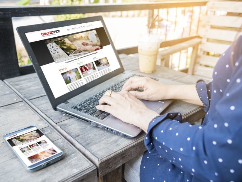 Online shopping, women browsing e-commerce website on laptop, online retail, digital commerce, Hozio, Inc.