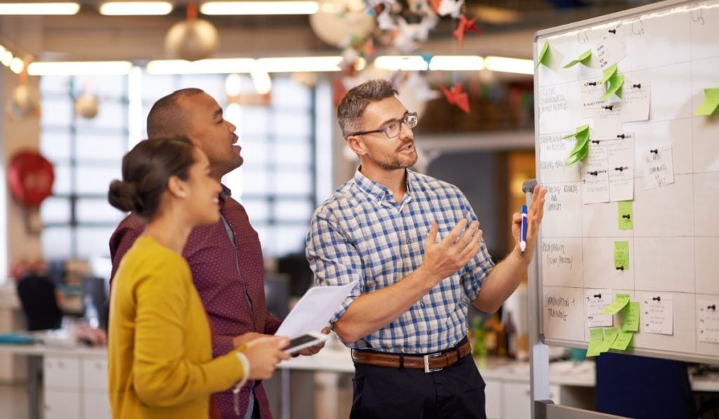 Flexible team collaboration brainstorming session in modern office environment.