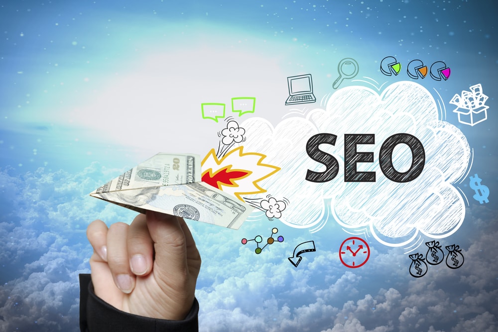 Cloud computing and SEO strategies with digital marketing icons and dollar bills.