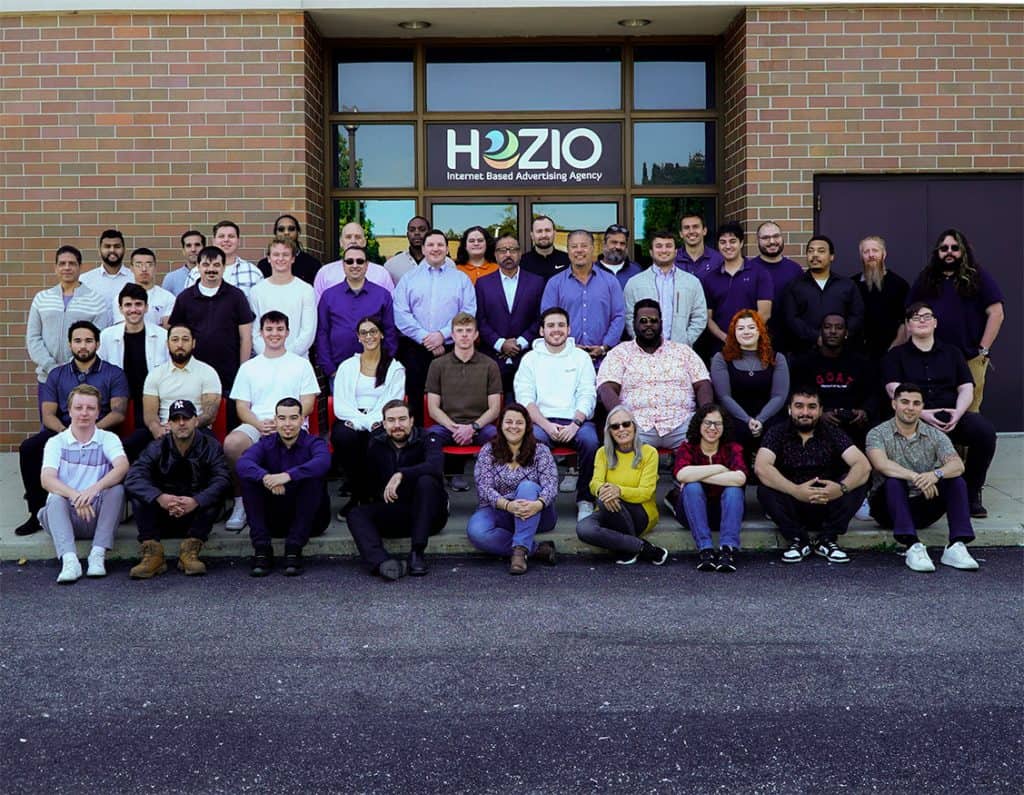 Group photo of Hozio Inc. team outside the office building.